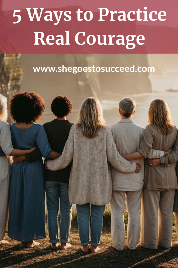 The image shows a group of people standing together with their arms around each other, facing a scenic view. Text at the top says, "5 Ways to Practice Real Courage." Below that is the website "www.shegoestosucceed.com."

